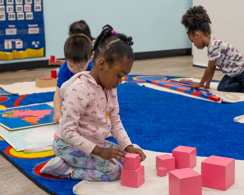 young child building with blocks