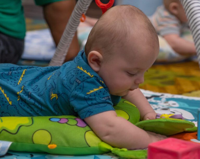 infant playing on play mat; sensory exploration