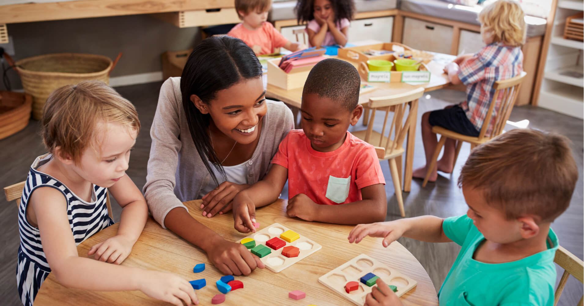 children learning shapes with a teacher
